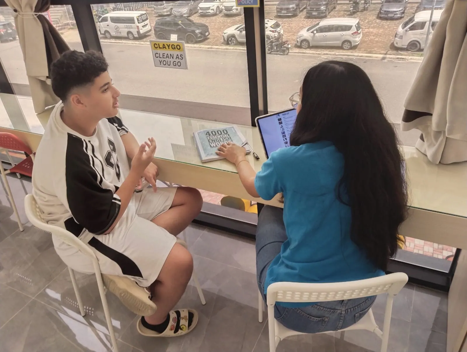 Abdullah in a one-to-one lesson with his teacher and a vocabulary book