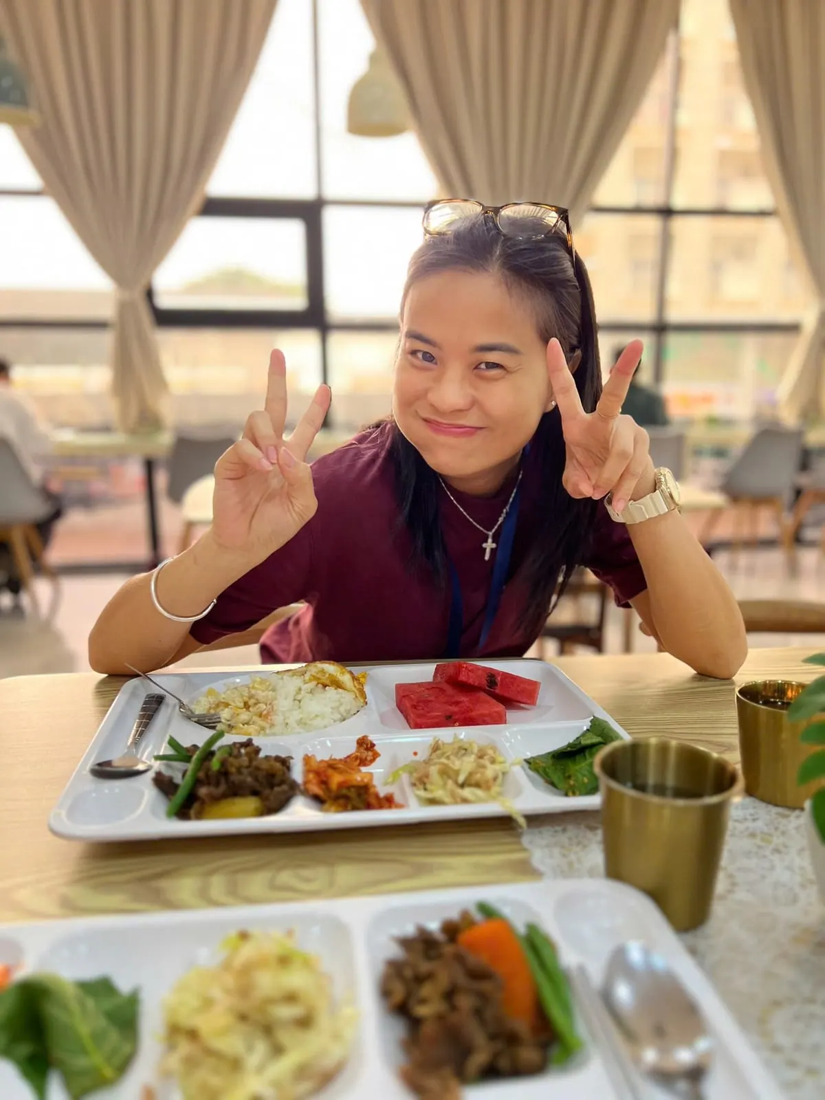 Hai Yen seated in front of a meal tray in the school canteen