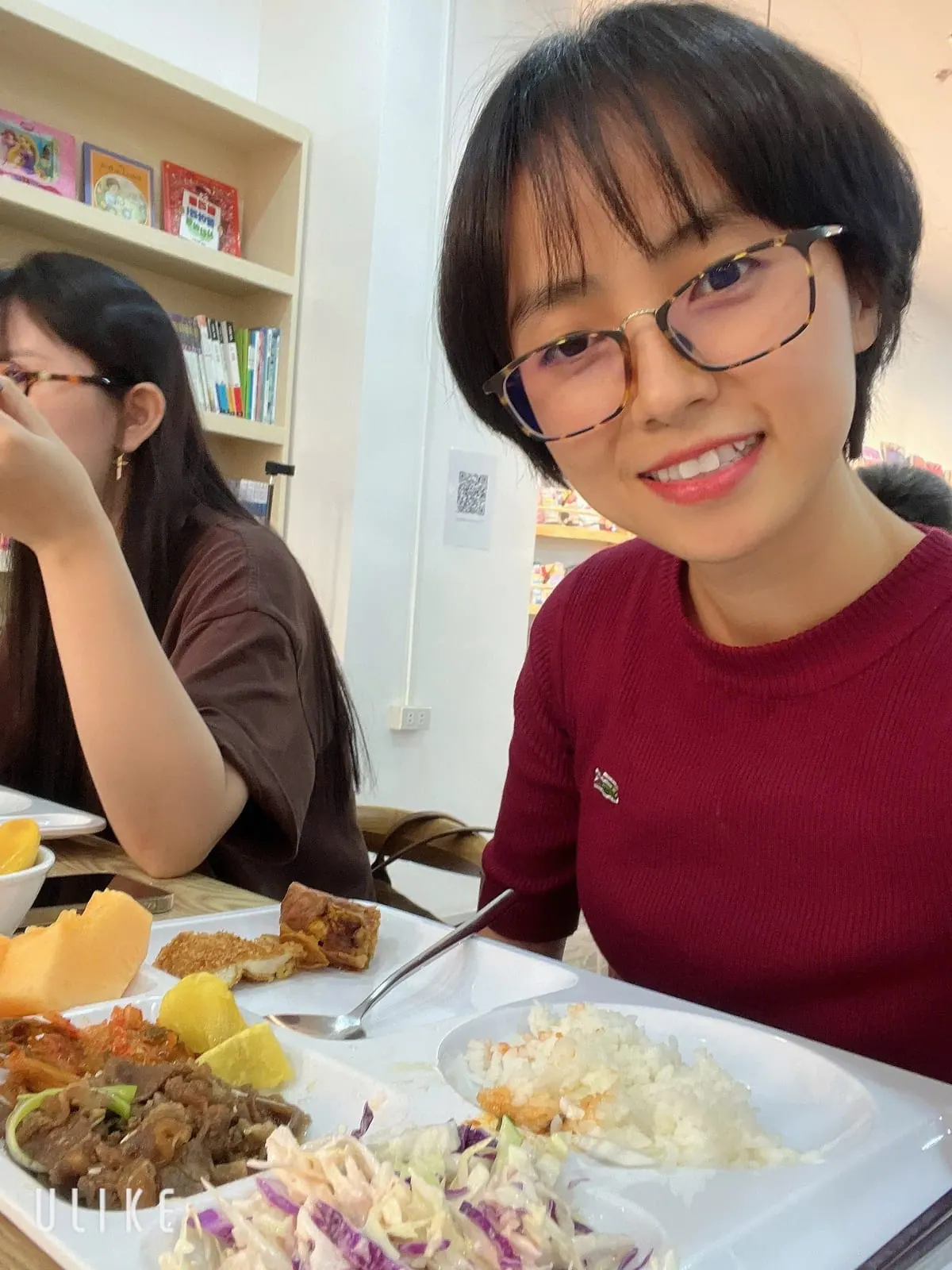Thu Hanh in the school canteen with a meal tray