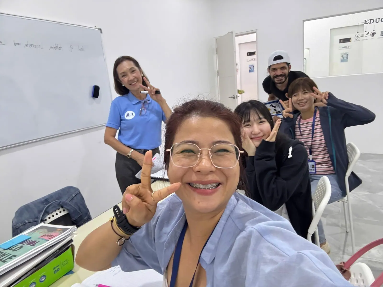 Thu Thao with classmates and a teacher in the classroom