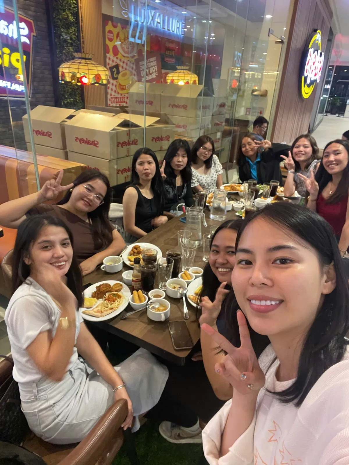 Students sitting around a restaurant table having dinner together after class