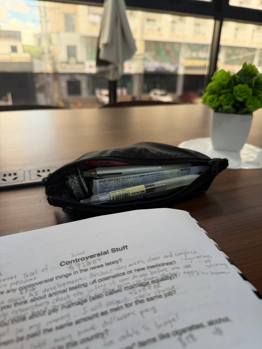 สมุดบนโต๊ะร้านกาแฟที่จดหัวข้อสนทนาของคาบเรียน